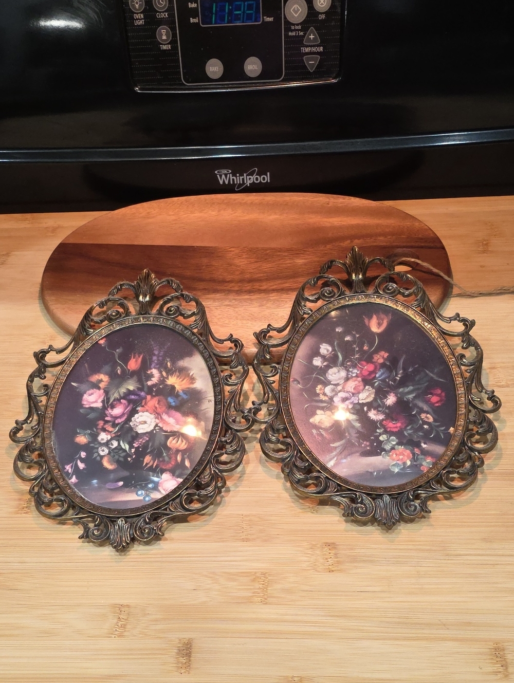 Pair of Brass Oval Framed Floral Prints in Convex Glass made in Italy.